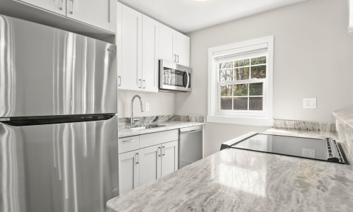a kitchen with white cabinets