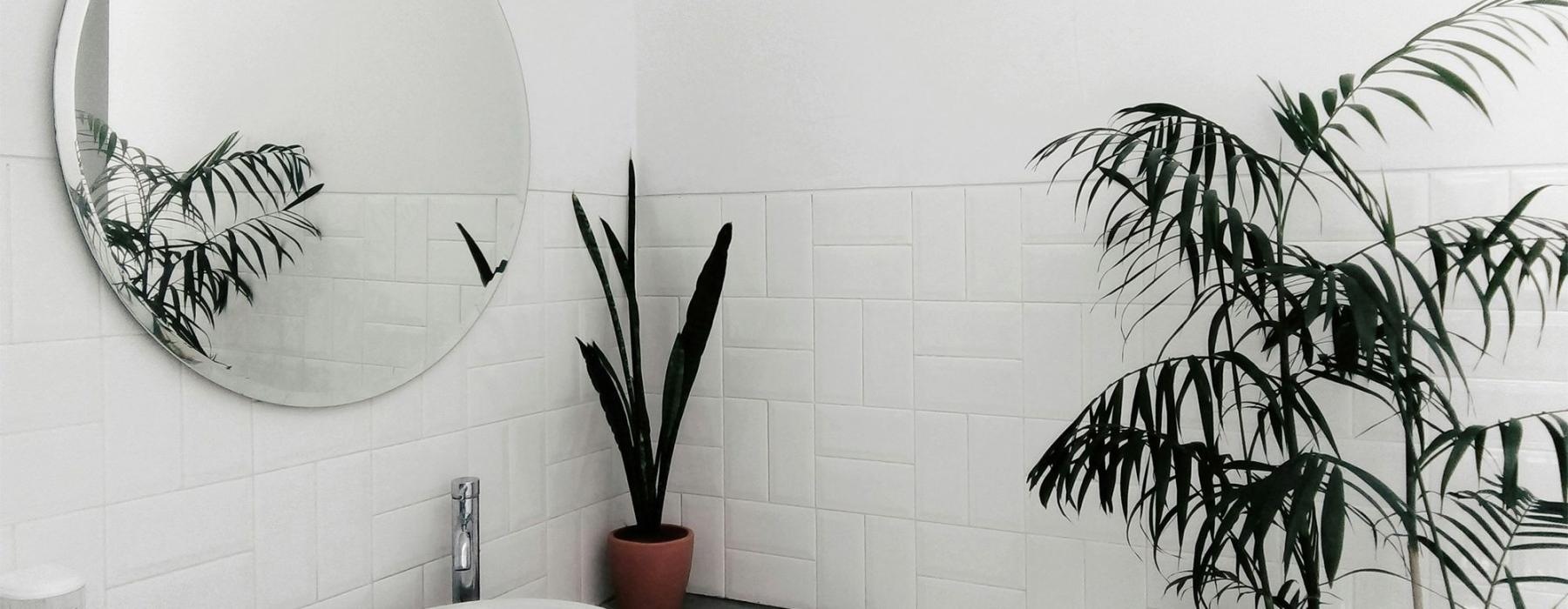 a bathroom with a round mirror